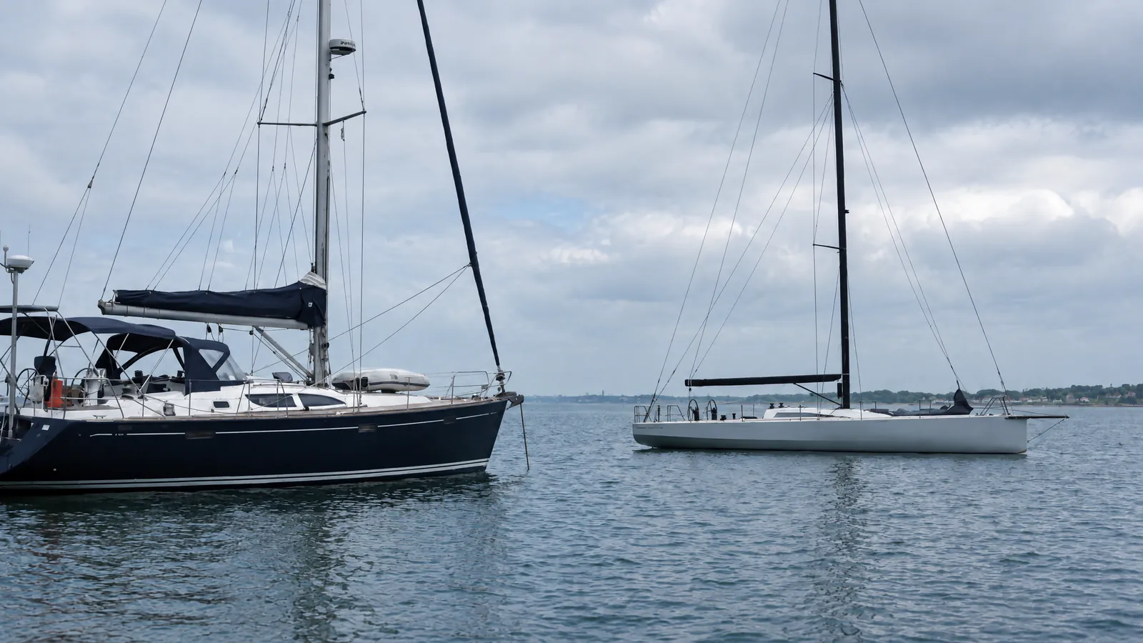 Un yate de crucero y un barco de regata desnudo, uno junto al otro